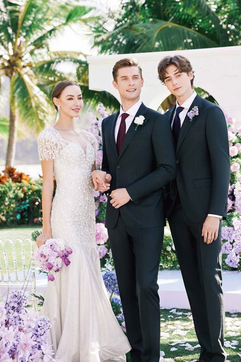 A bride and groom are posing for a picture with two men in suits.