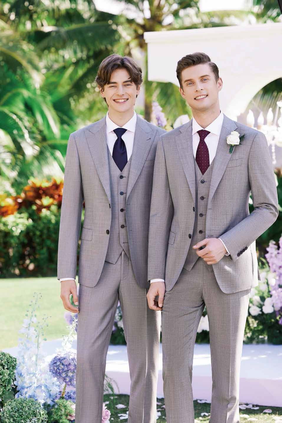 Two men in suits and ties are standing next to each other.