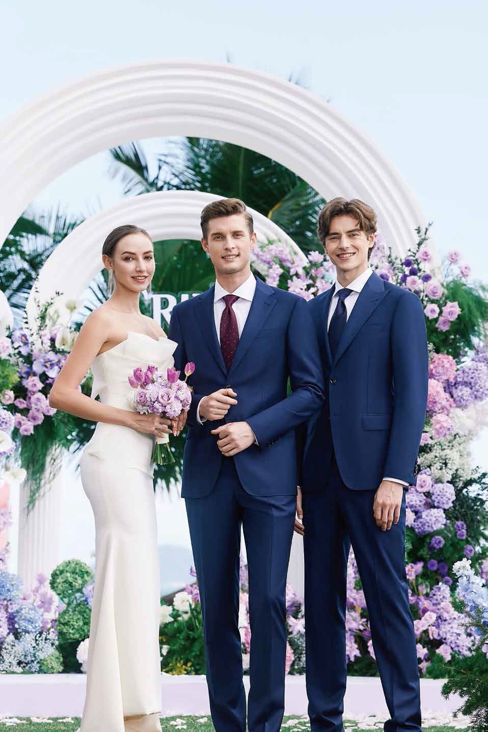 A bride and groom are posing for a picture with two men in suits.
