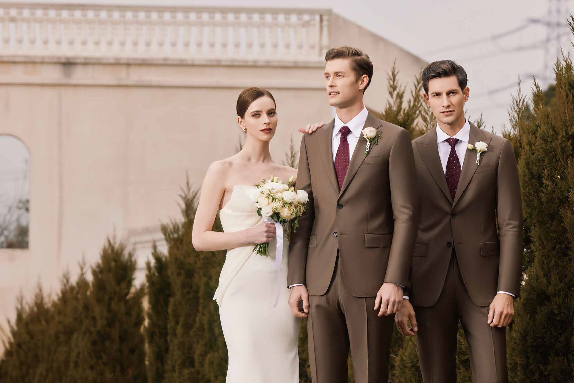 A bride and her groomsmen are standing next to each other in front of a building.