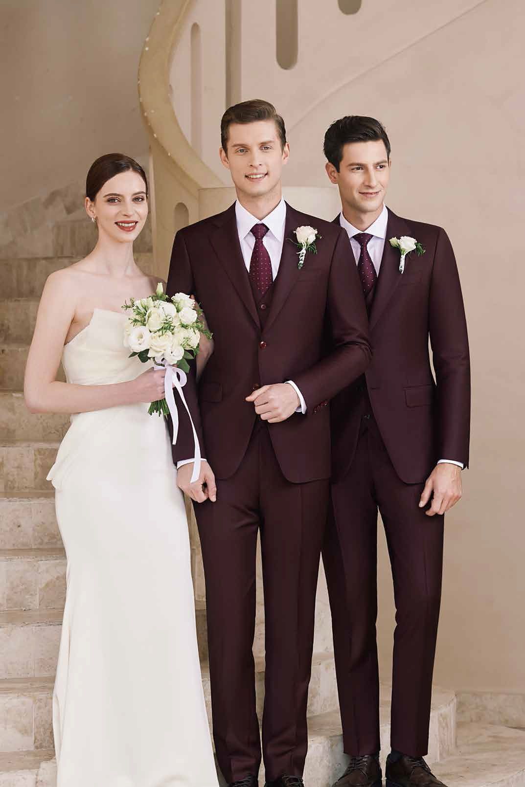 A bride and her two groomsmen are standing next to each other on a set of stairs.