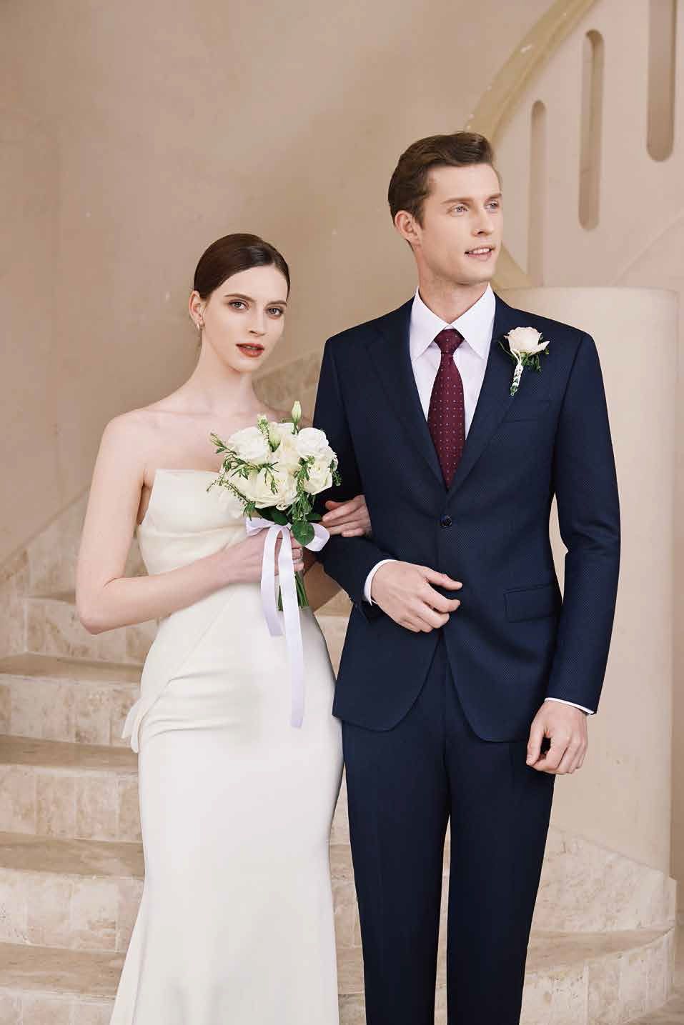 A bride and groom are standing next to each other on a set of stairs.