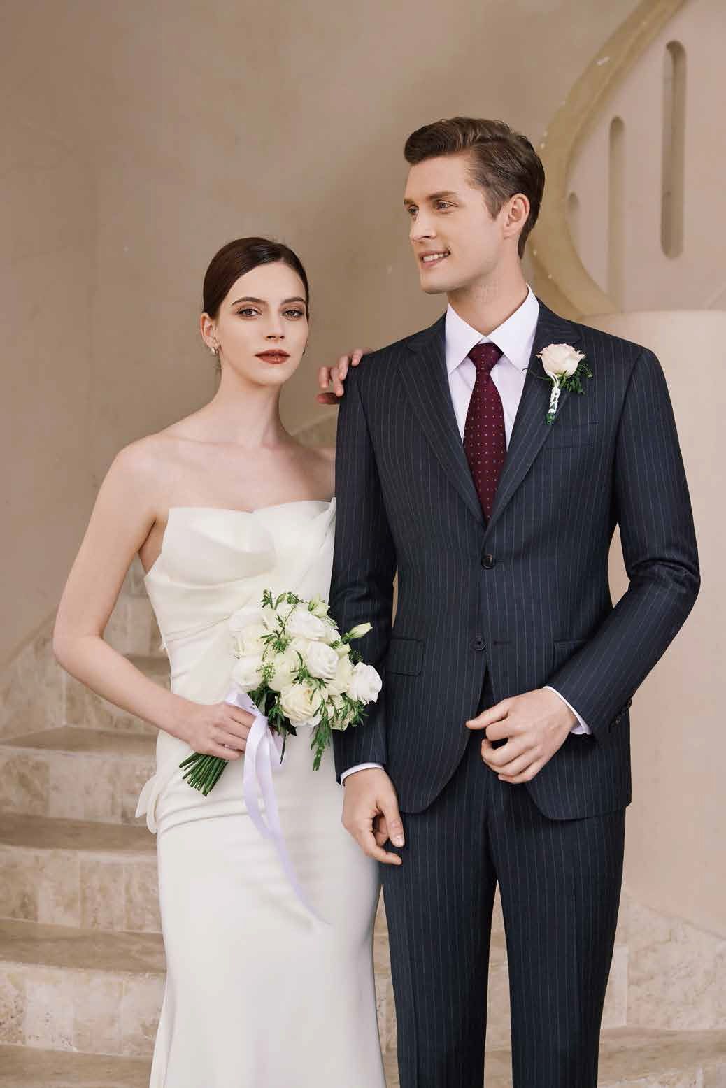A bride and groom are standing next to each other on a set of stairs.