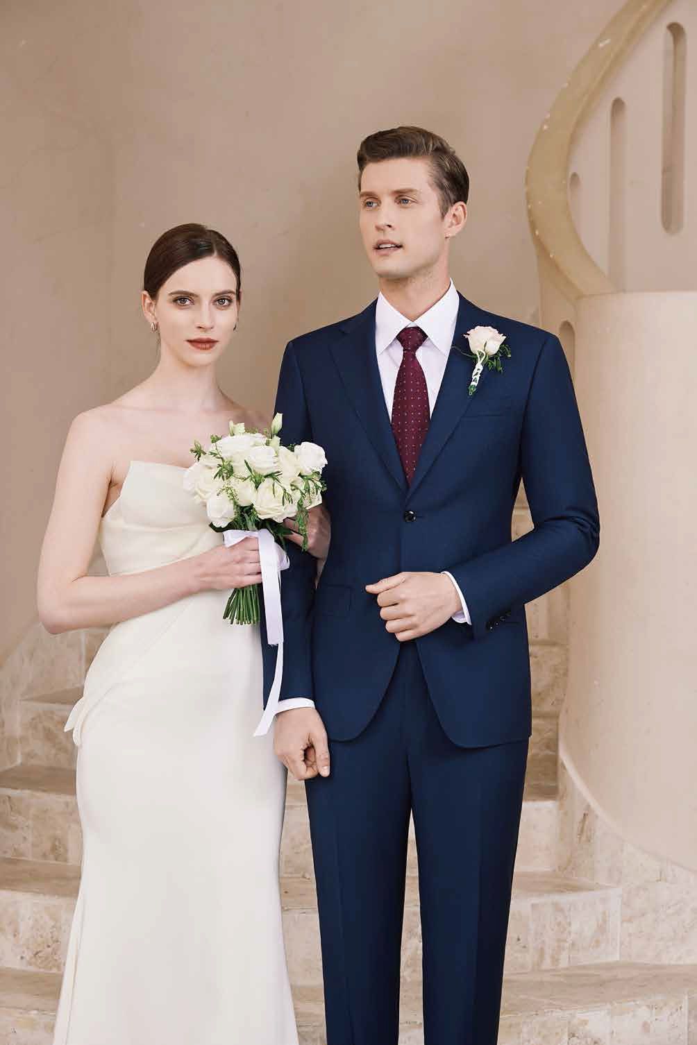 A bride and groom are standing next to each other on a set of stairs.