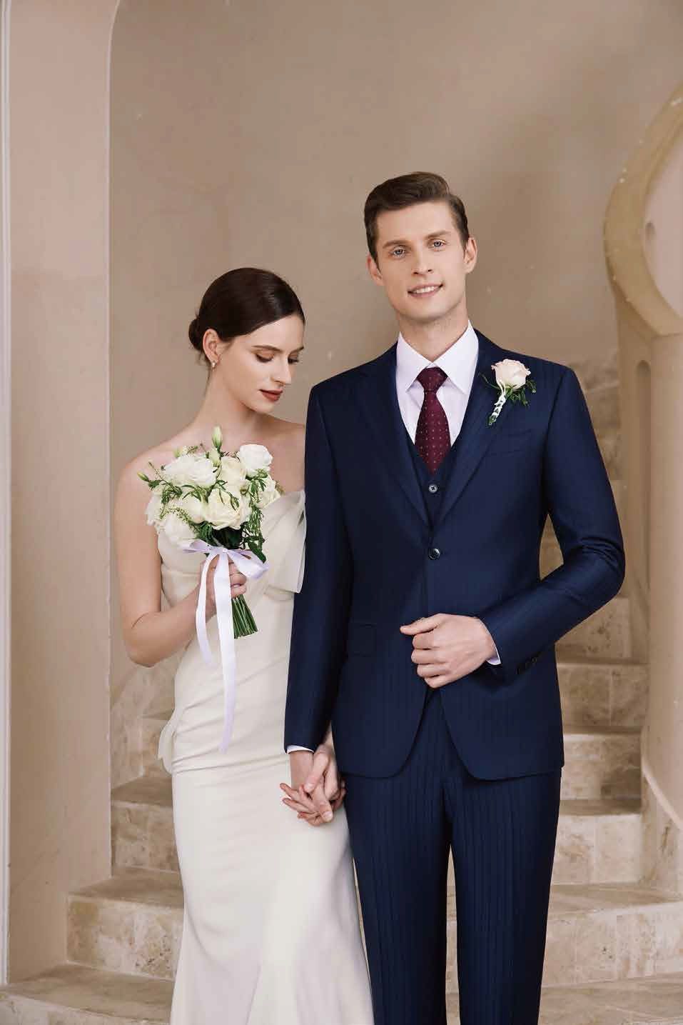 A bride and groom are standing next to each other on a set of stairs holding hands.