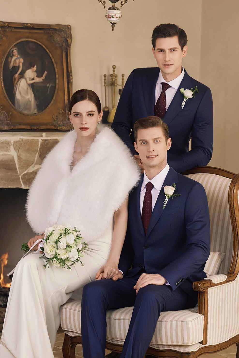 A bride and groom are posing for a picture with two men in suits.