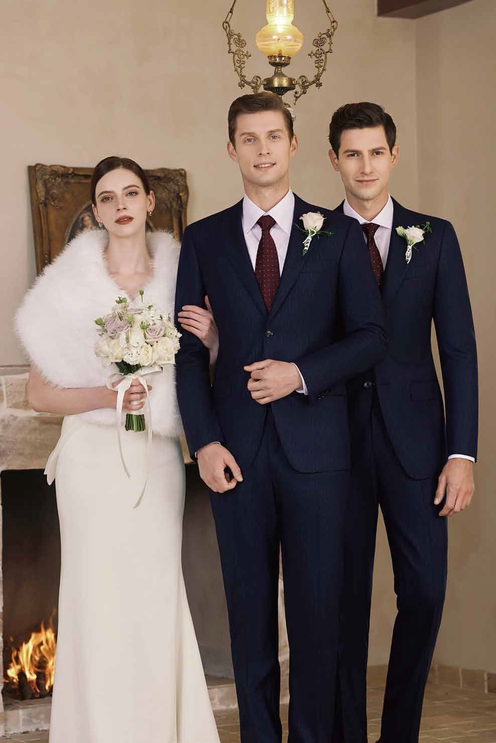 A bride and her two groomsmen are posing for a picture in front of a fireplace.