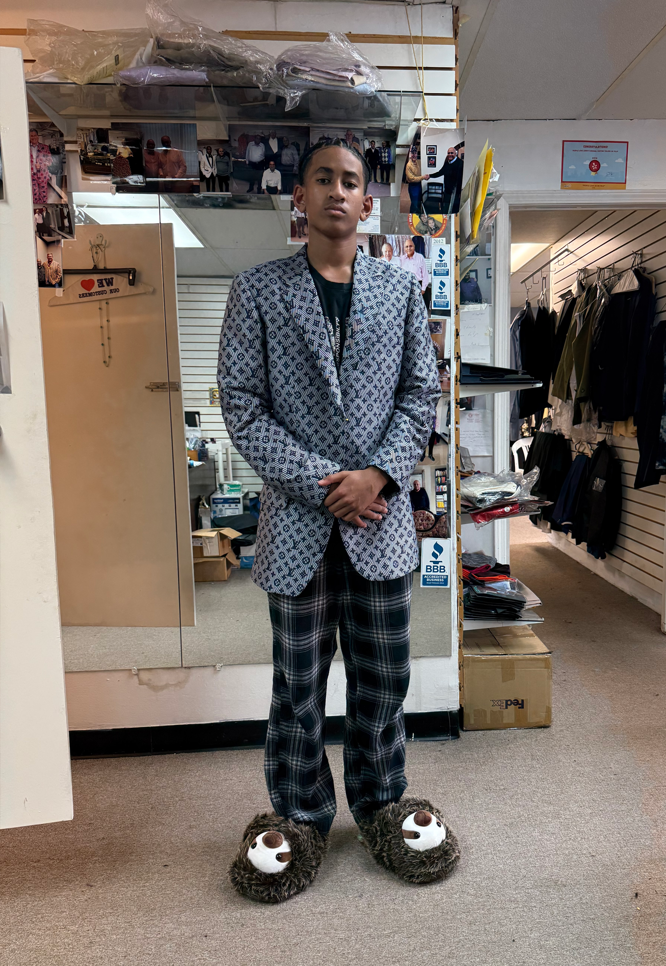 Person in patterned suit and sloth slippers, standing indoors in a store.