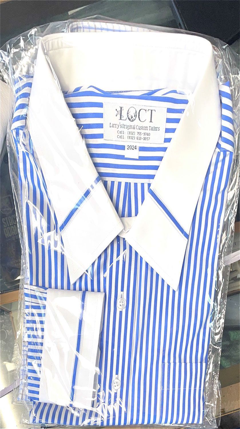 A blue and white striped shirt is wrapped in plastic