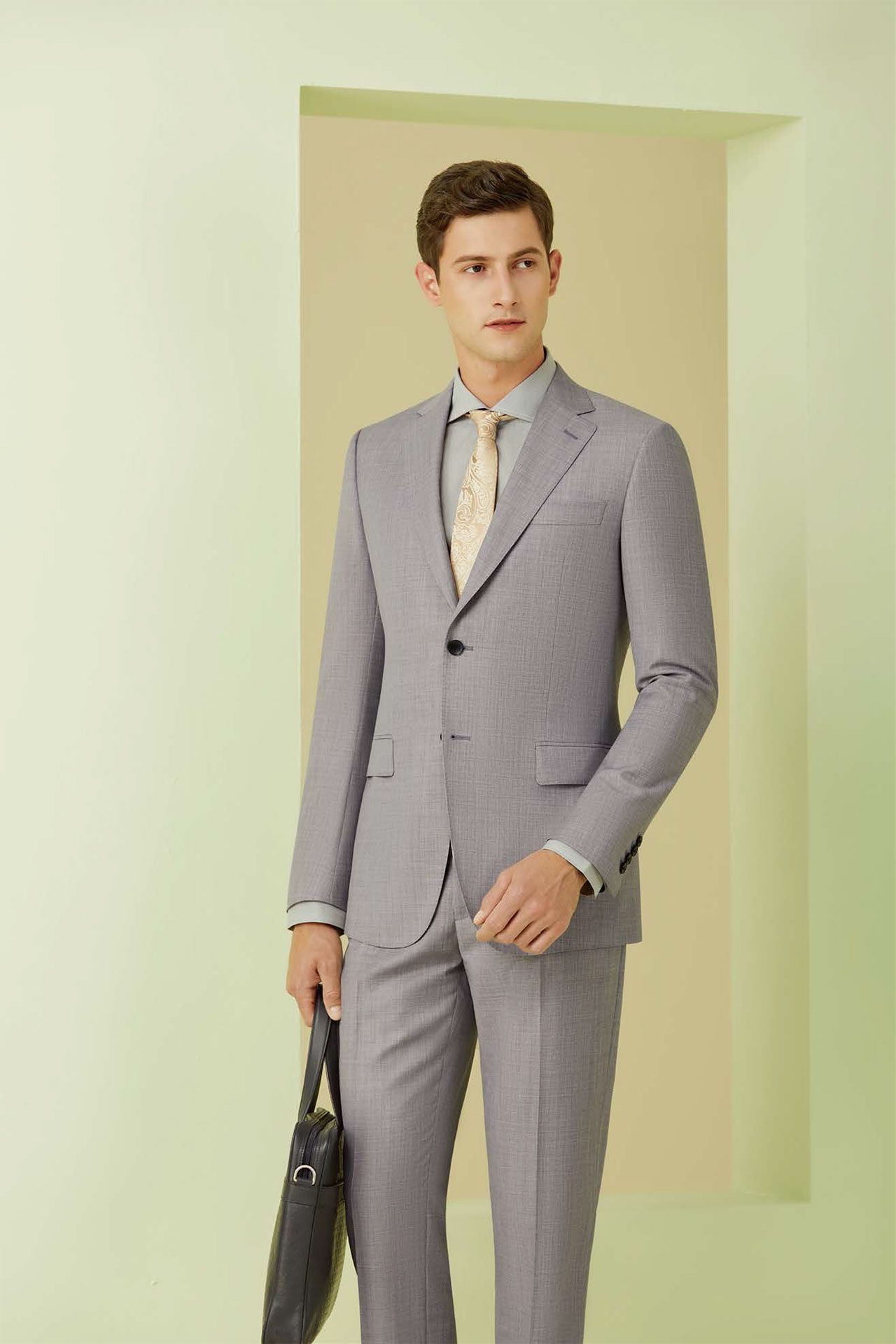 A man in a suit and tie is holding a briefcase