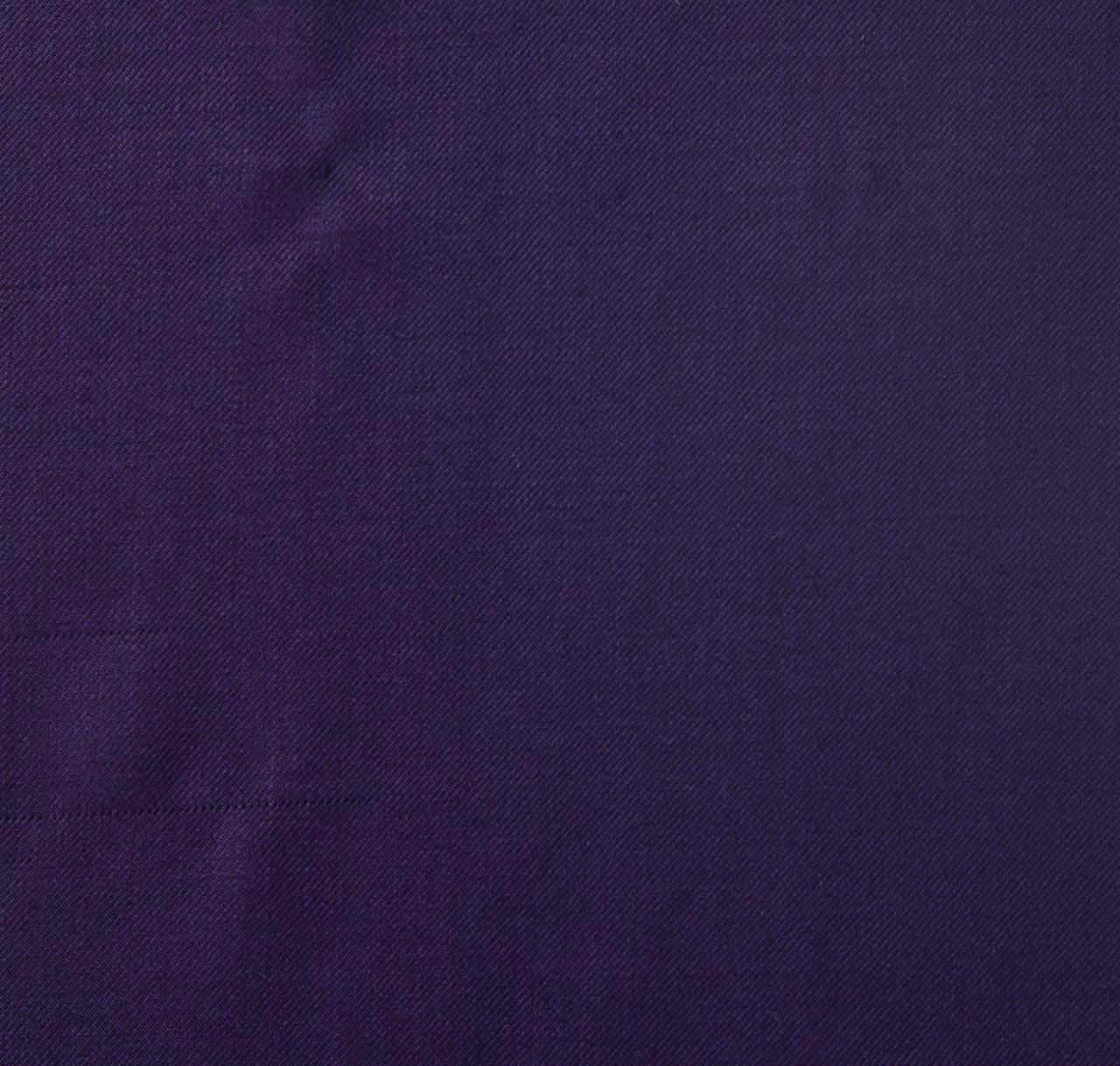 A close up of a dark purple fabric texture