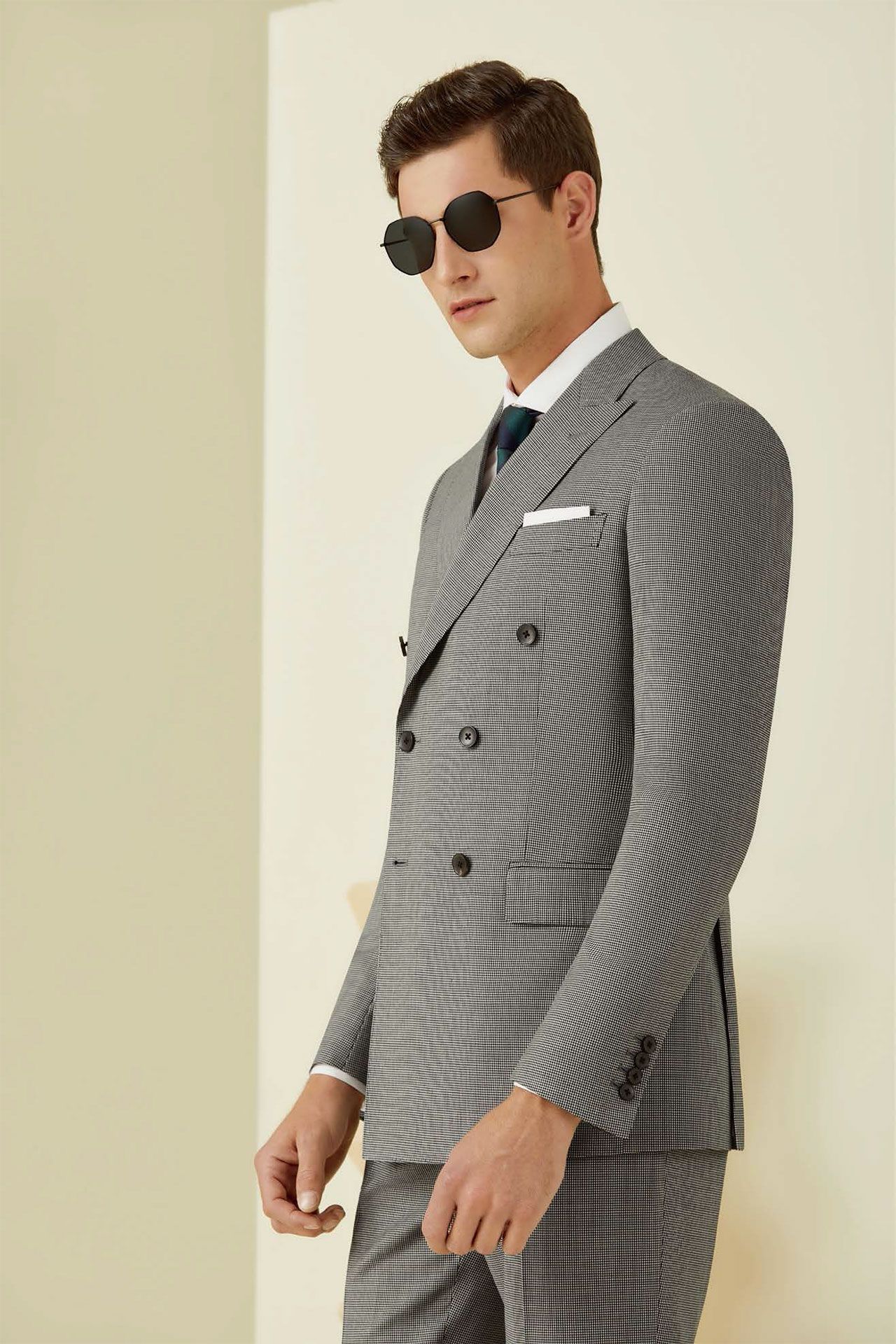 A man wearing a suit and sunglasses