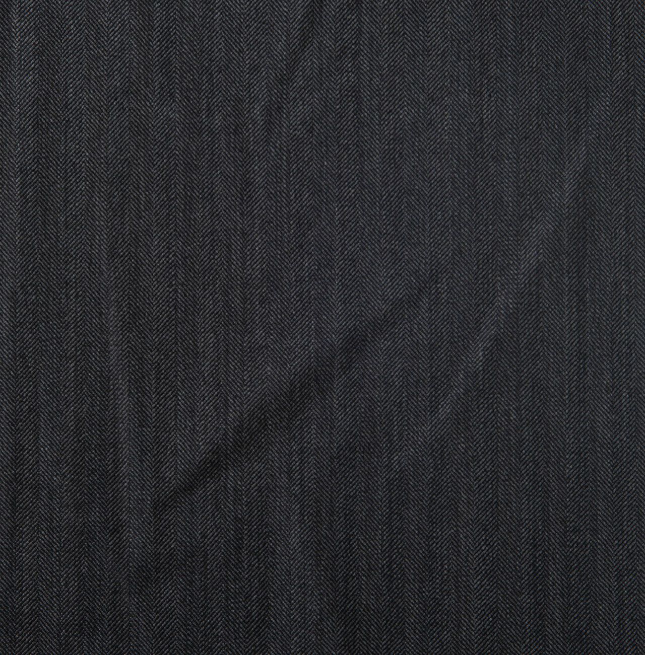 A close up of a piece of grey herringbone fabric
