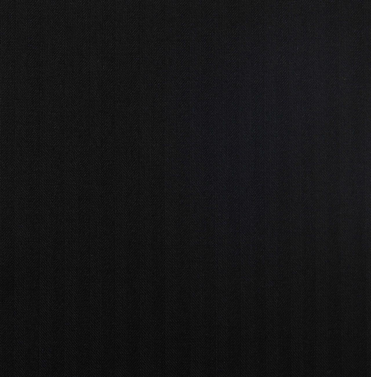 A close up of a black herringbone fabric