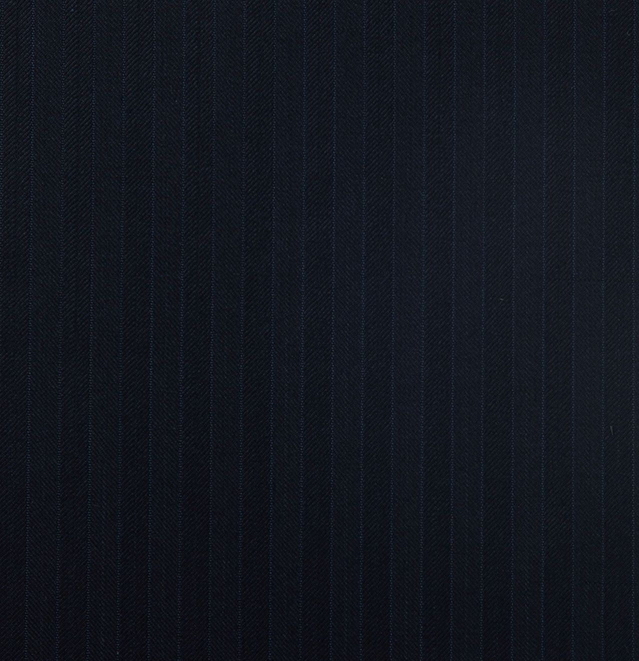 A close up of a dark navy fabric with a striped pattern