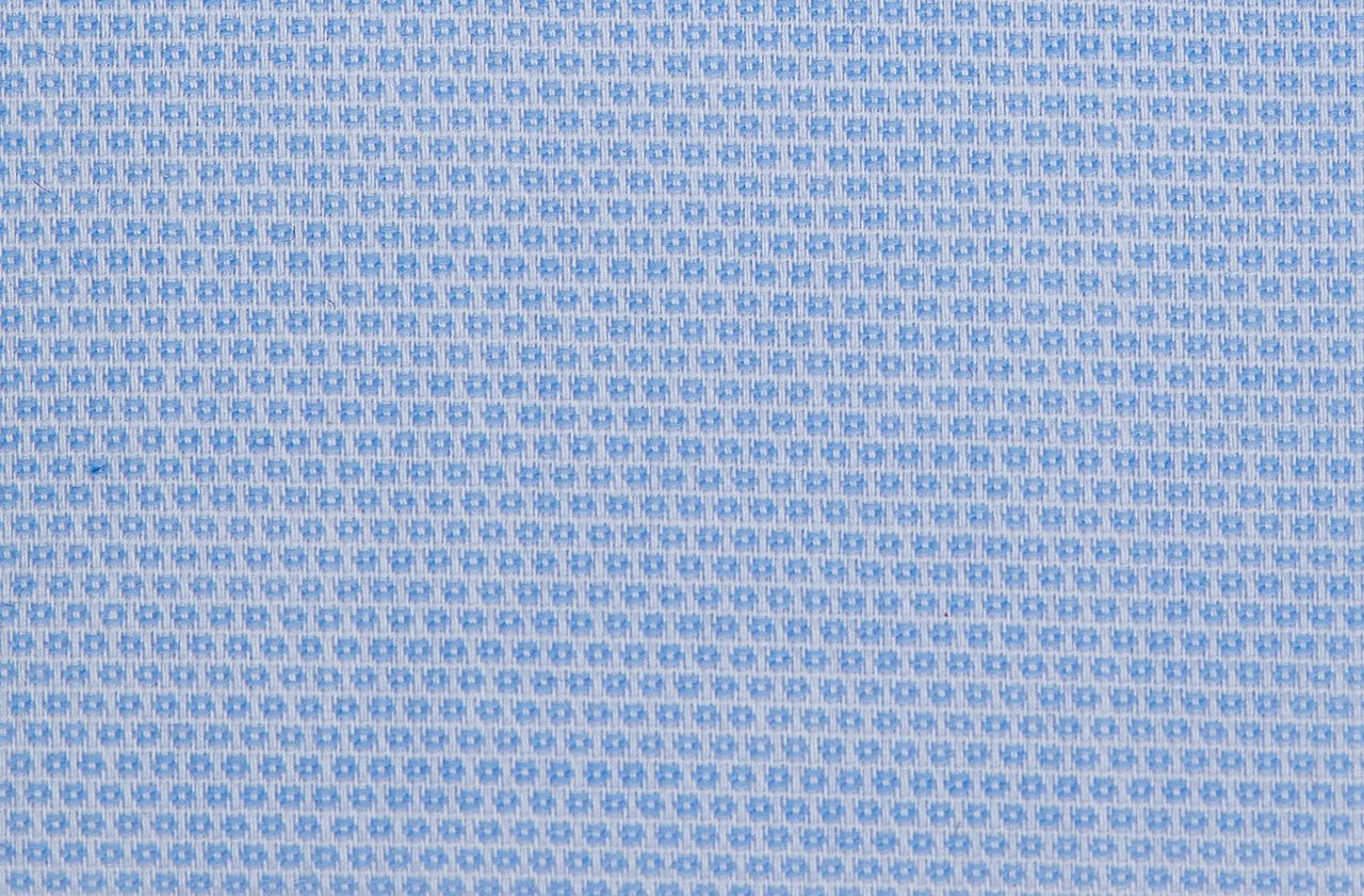 A close up of a blue and white polka dot fabric