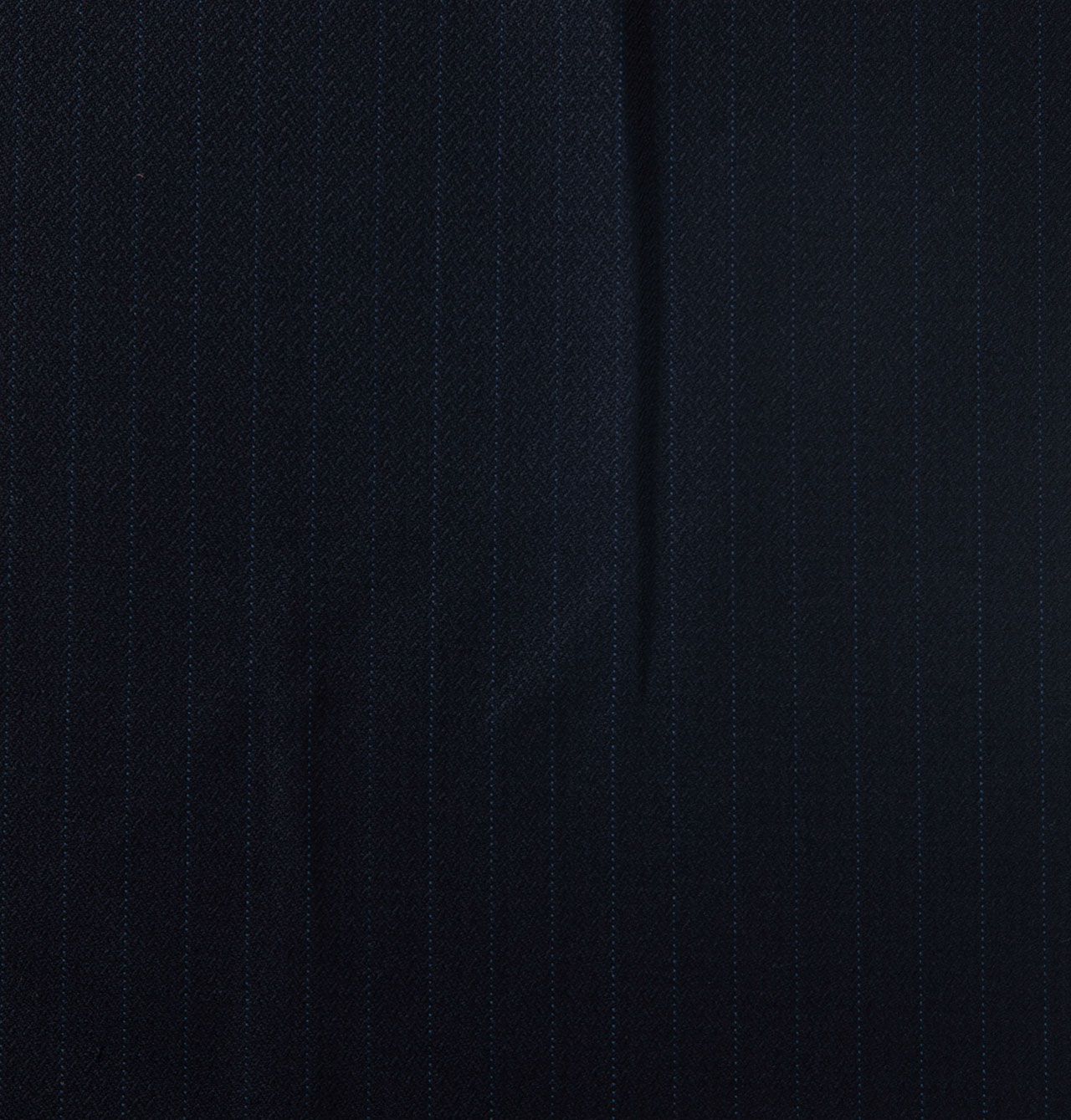 A close up of a piece of dark navy with a striped pattern