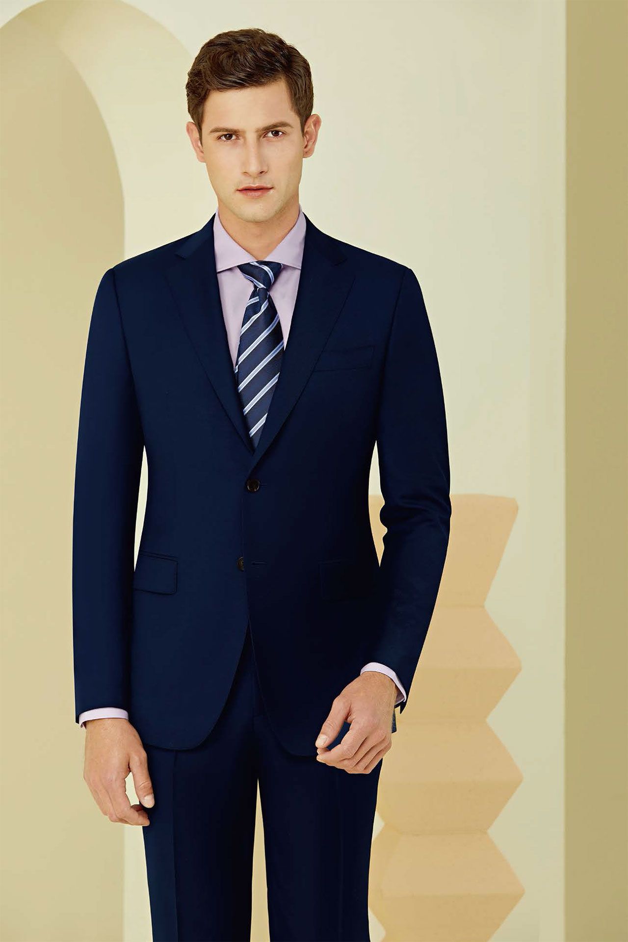 A man is wearing a blue suit and tie