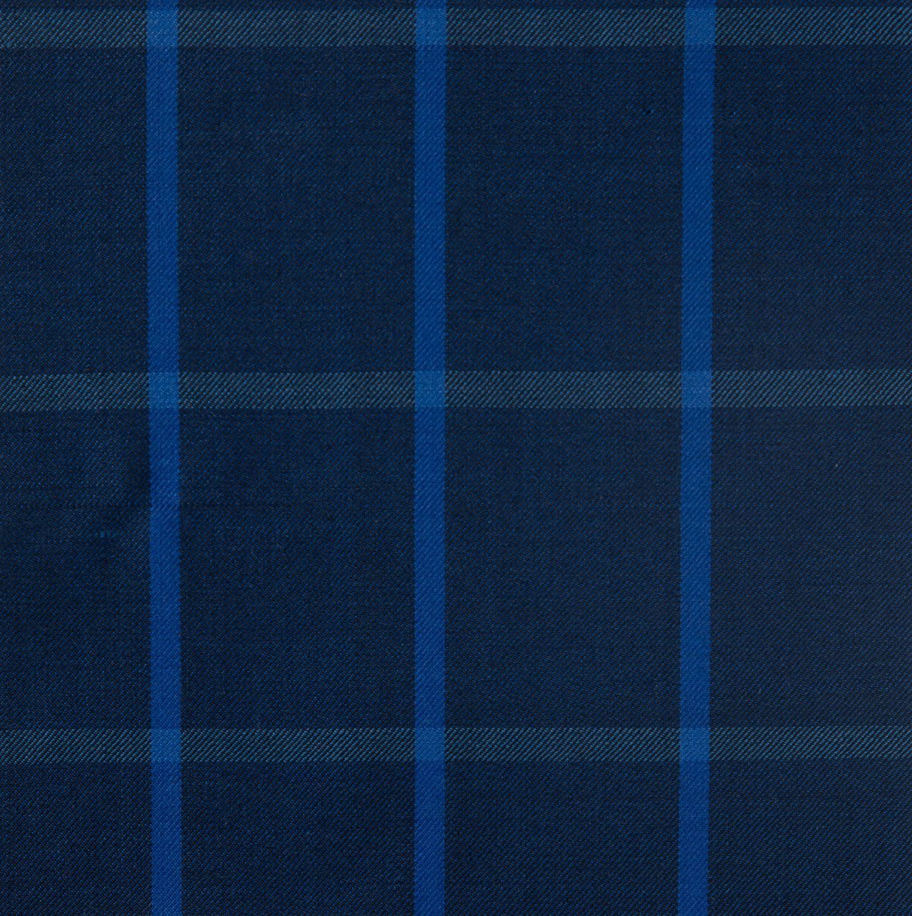 A close up of a blue plaid fabric with blue stripes