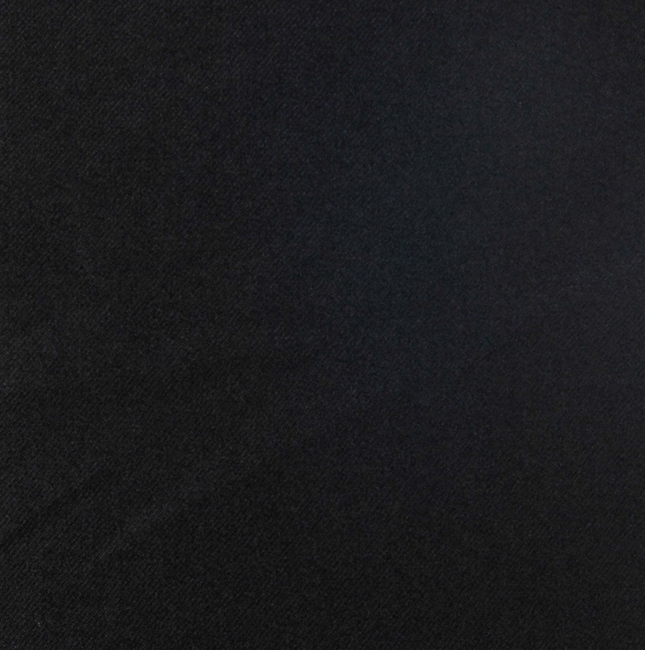 A close up of a black surface with a grainy texture