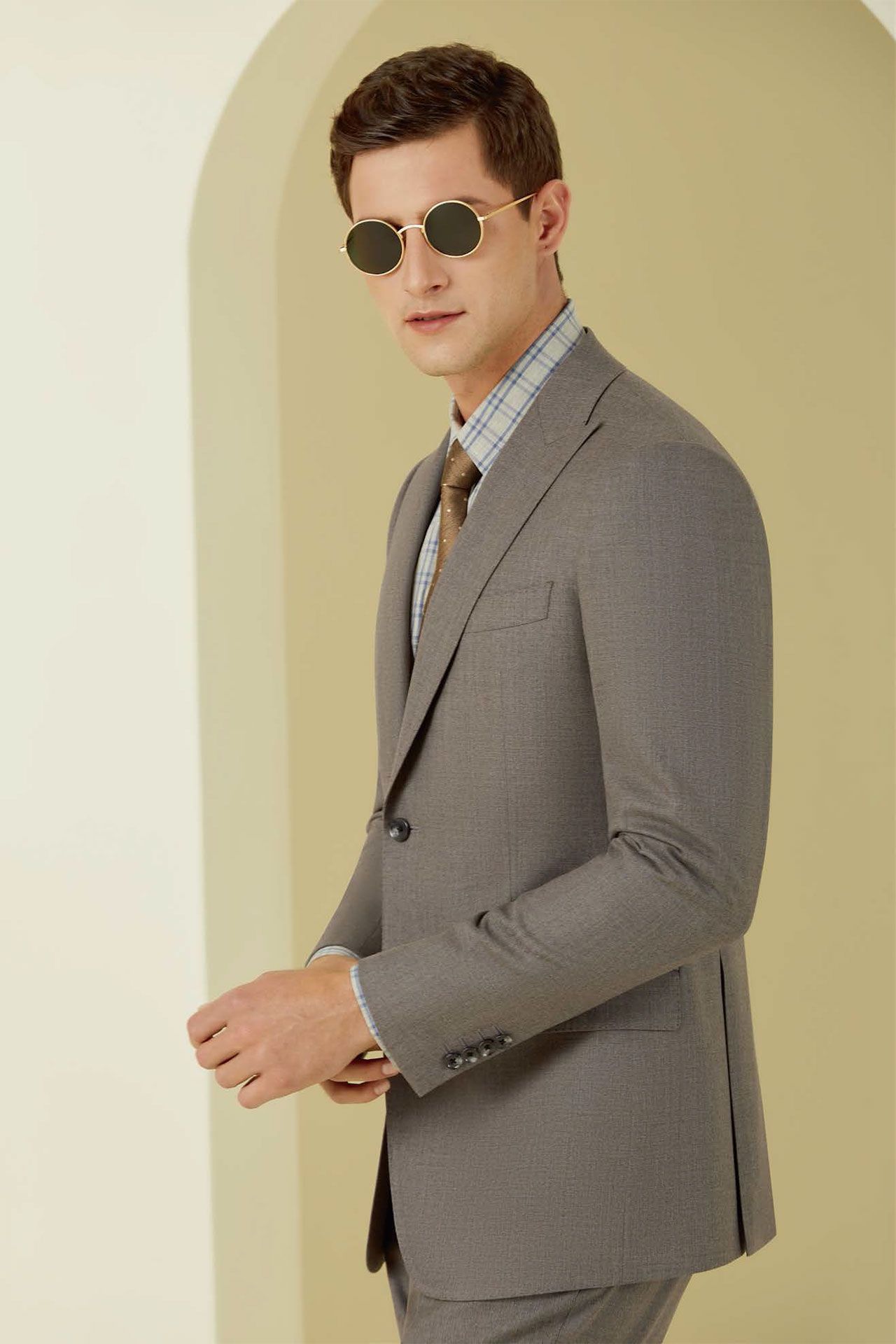A man in a suit and tie is wearing sunglasses