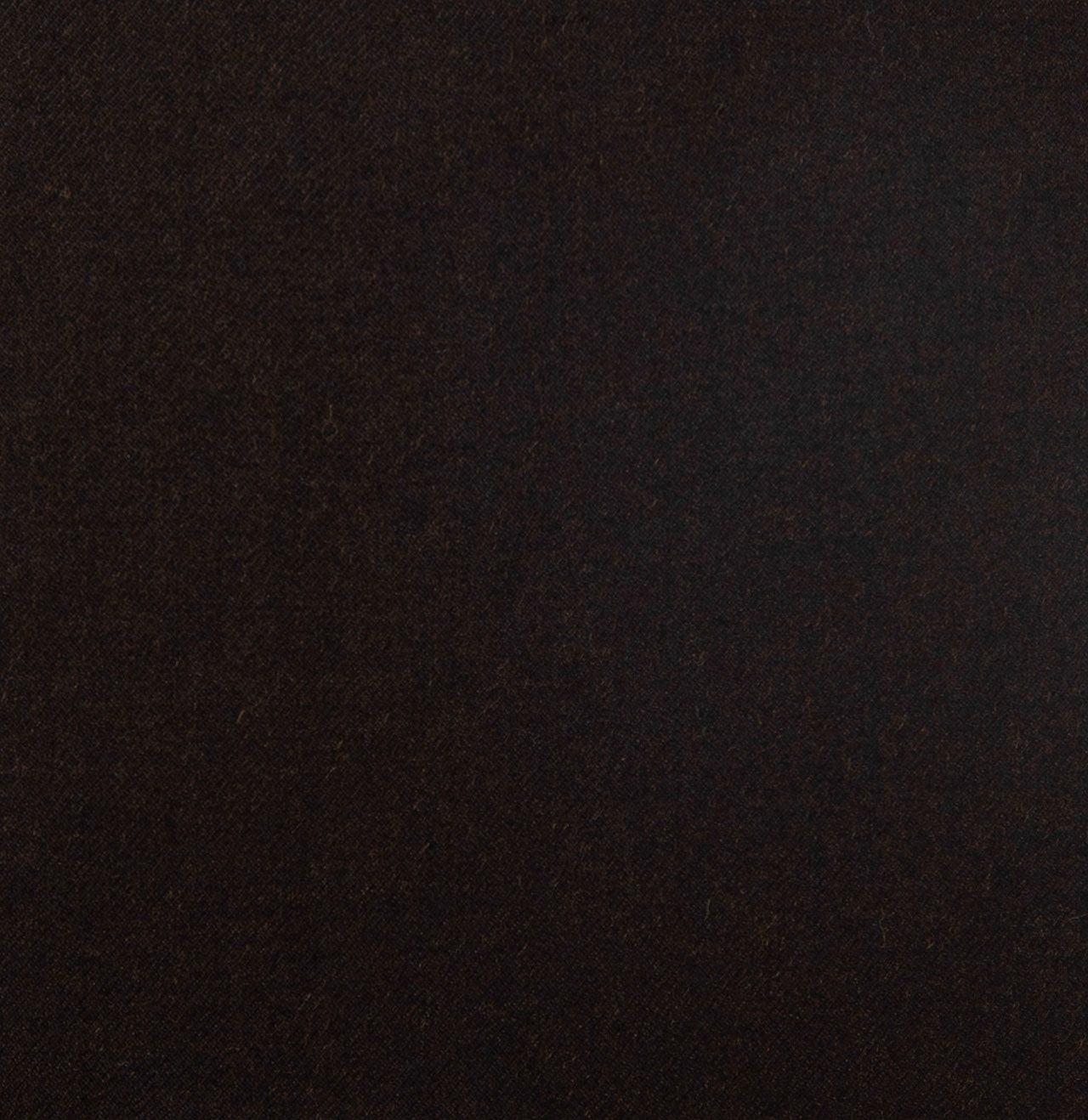 A close up of a black surface with a grainy texture