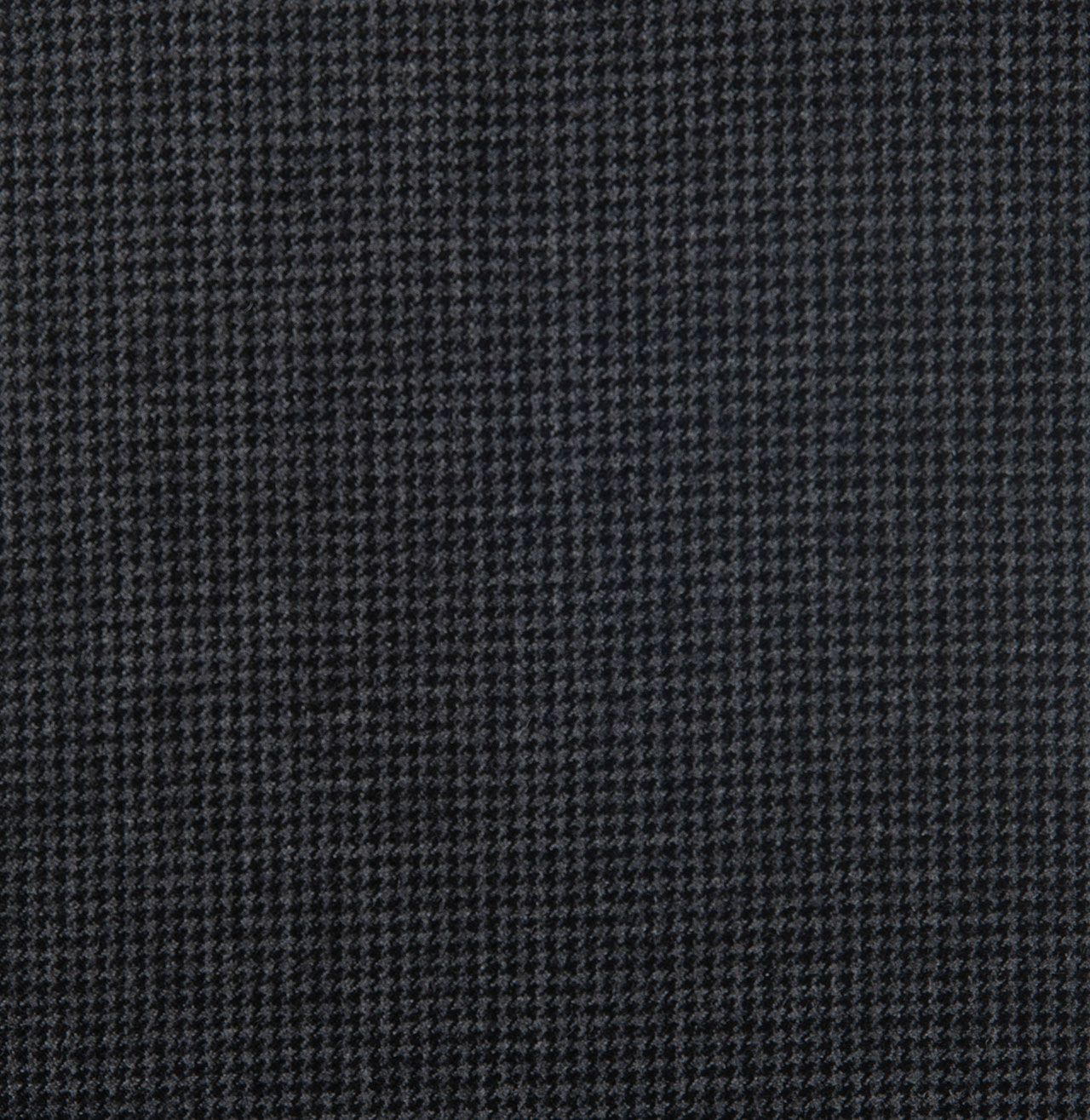 A close up of a black fabric with a checkered pattern