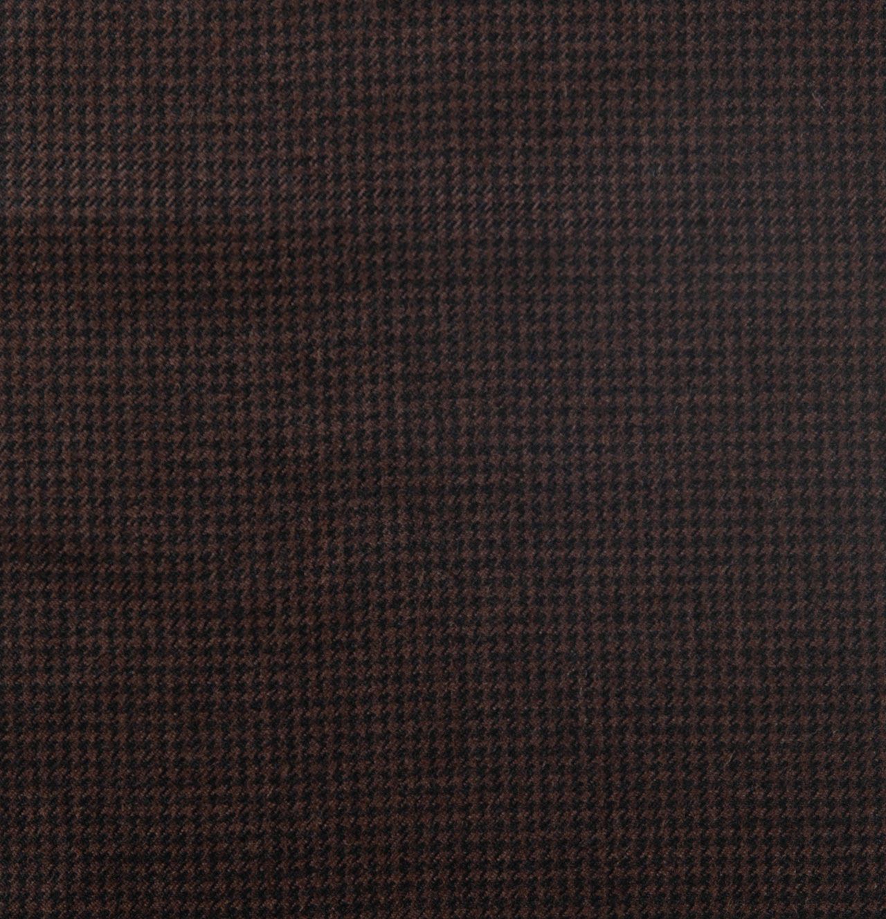 A close up of a brown fabric with a checkered pattern