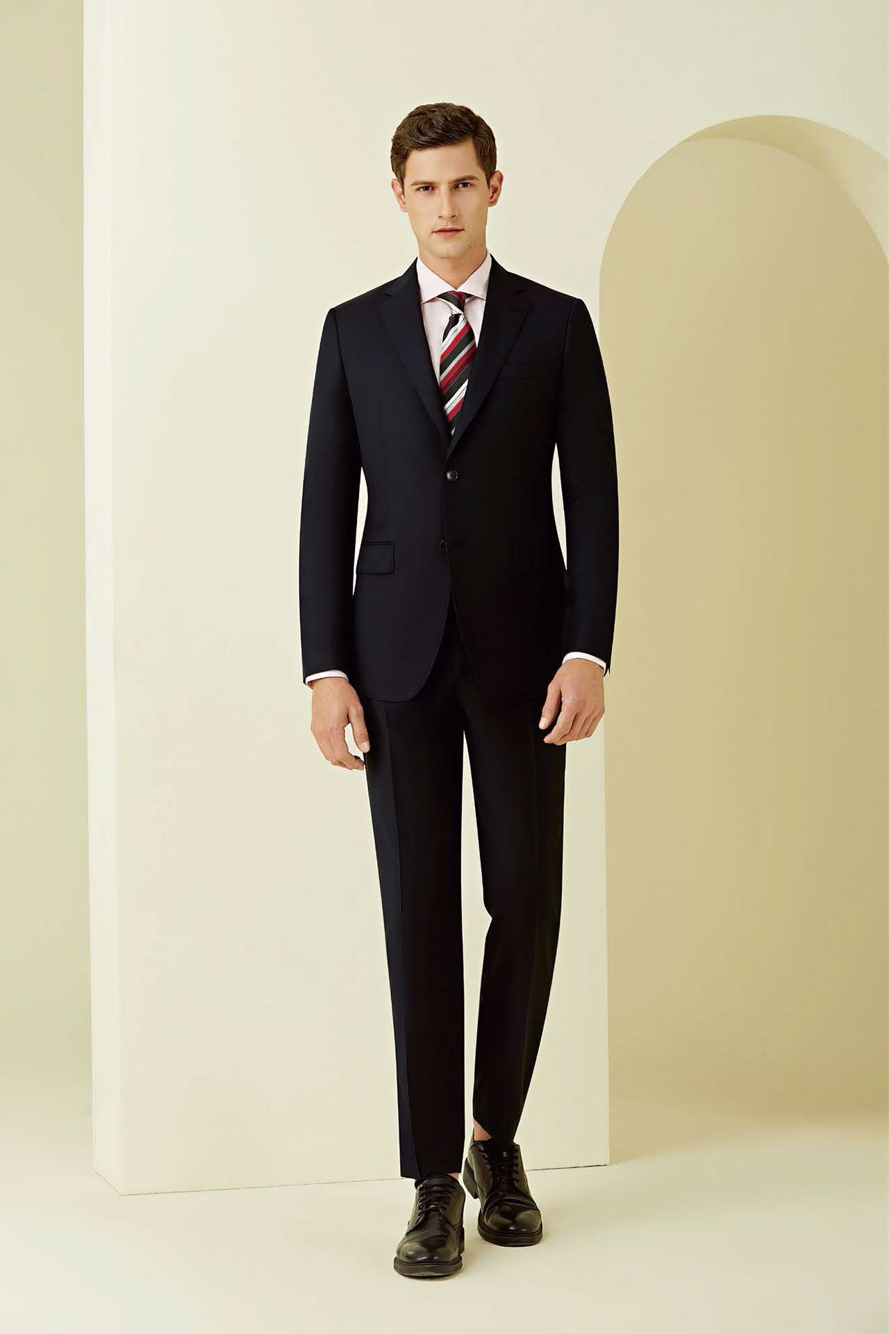 A man in a suit and tie is standing