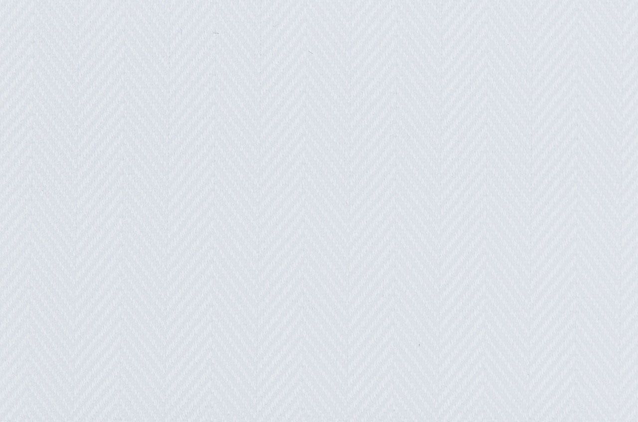 A close up of a white fabric with a pattern on it