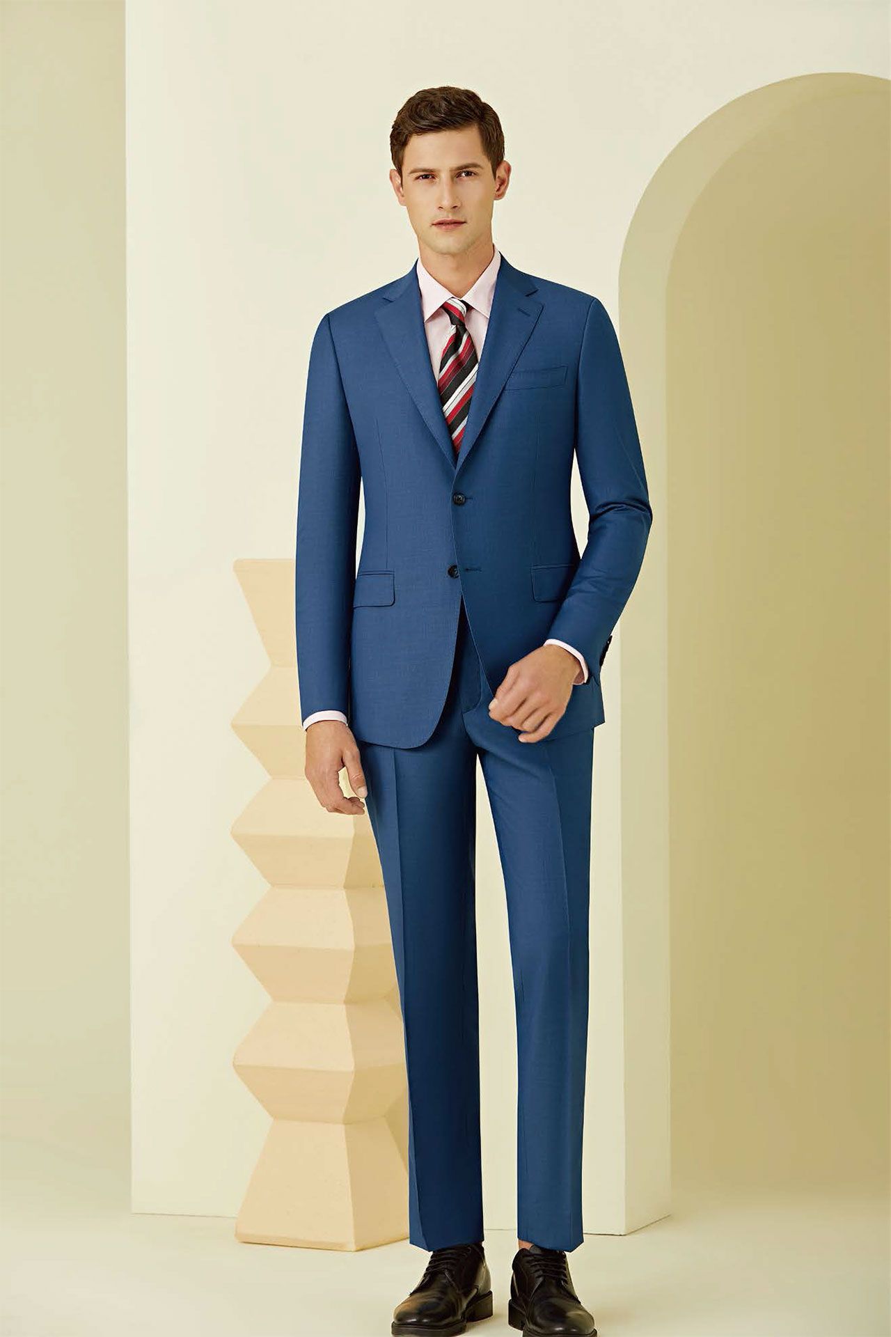 A man is wearing a blue suit and ti
