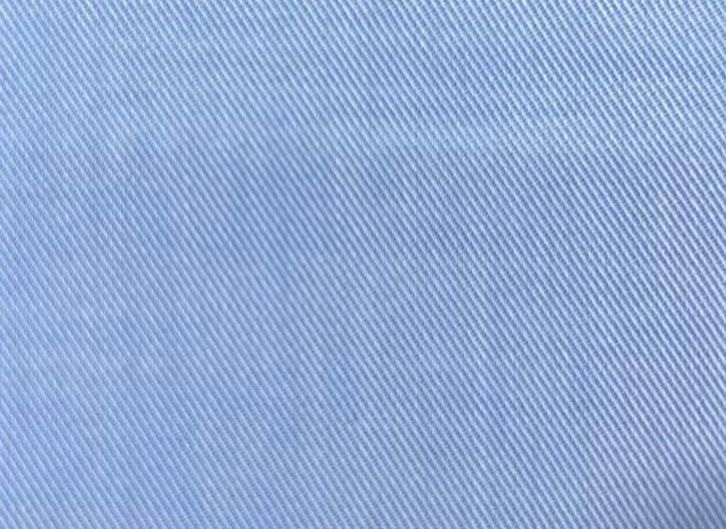 A close up of a light blue denim fabric texture