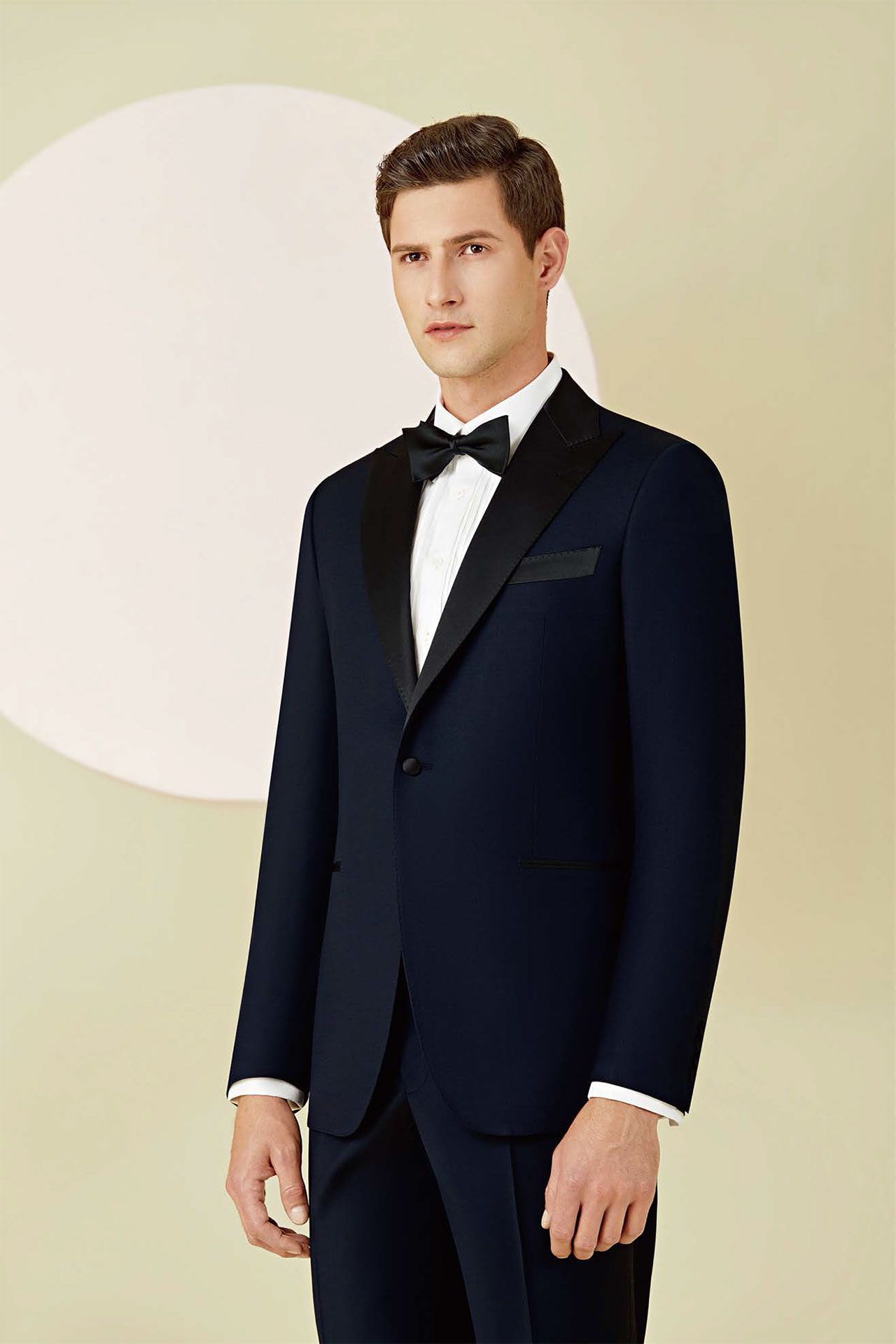 A man is wearing a tuxedo and bow tie