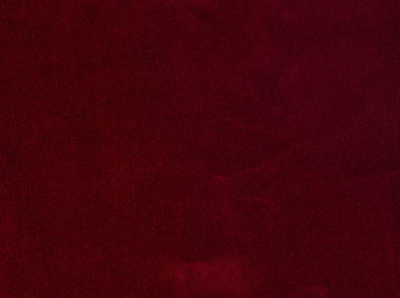 A close up of a red velvet fabric texture