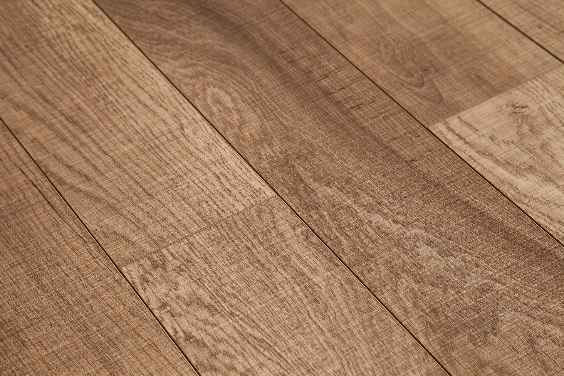 Close-up of diagonally-laid wood-look flooring, in varying shades of brown, with visible grain details.