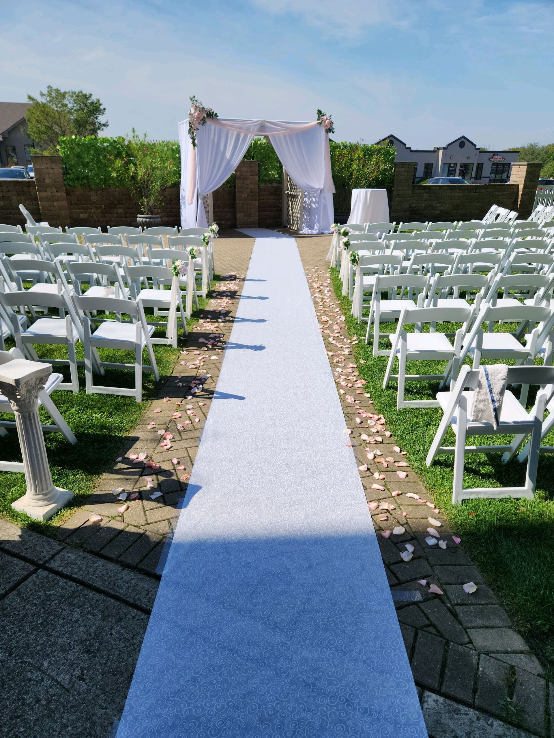 A white aisle with white chairs and a white carpet