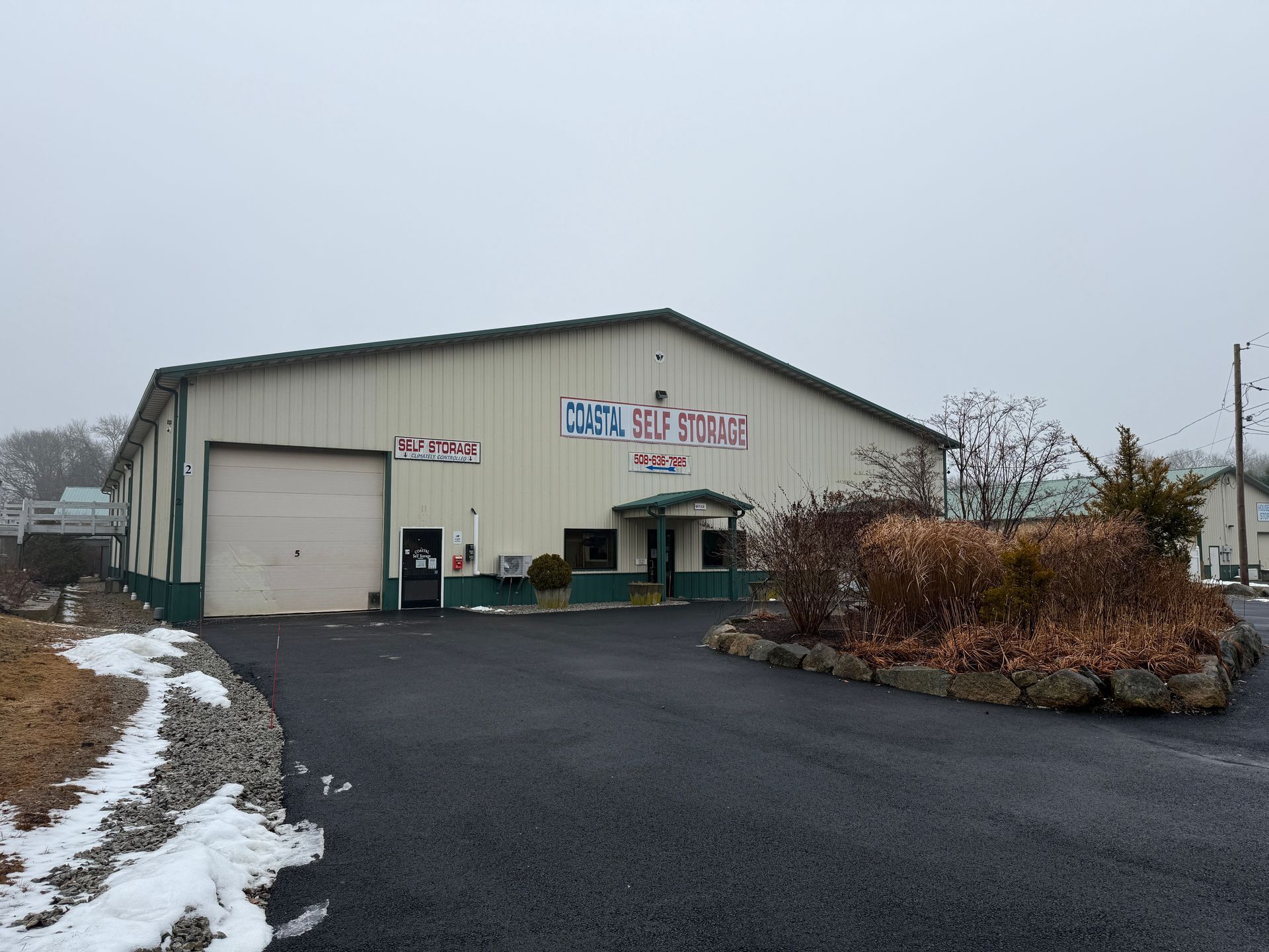 Large commercial building, asphalt driveway. 