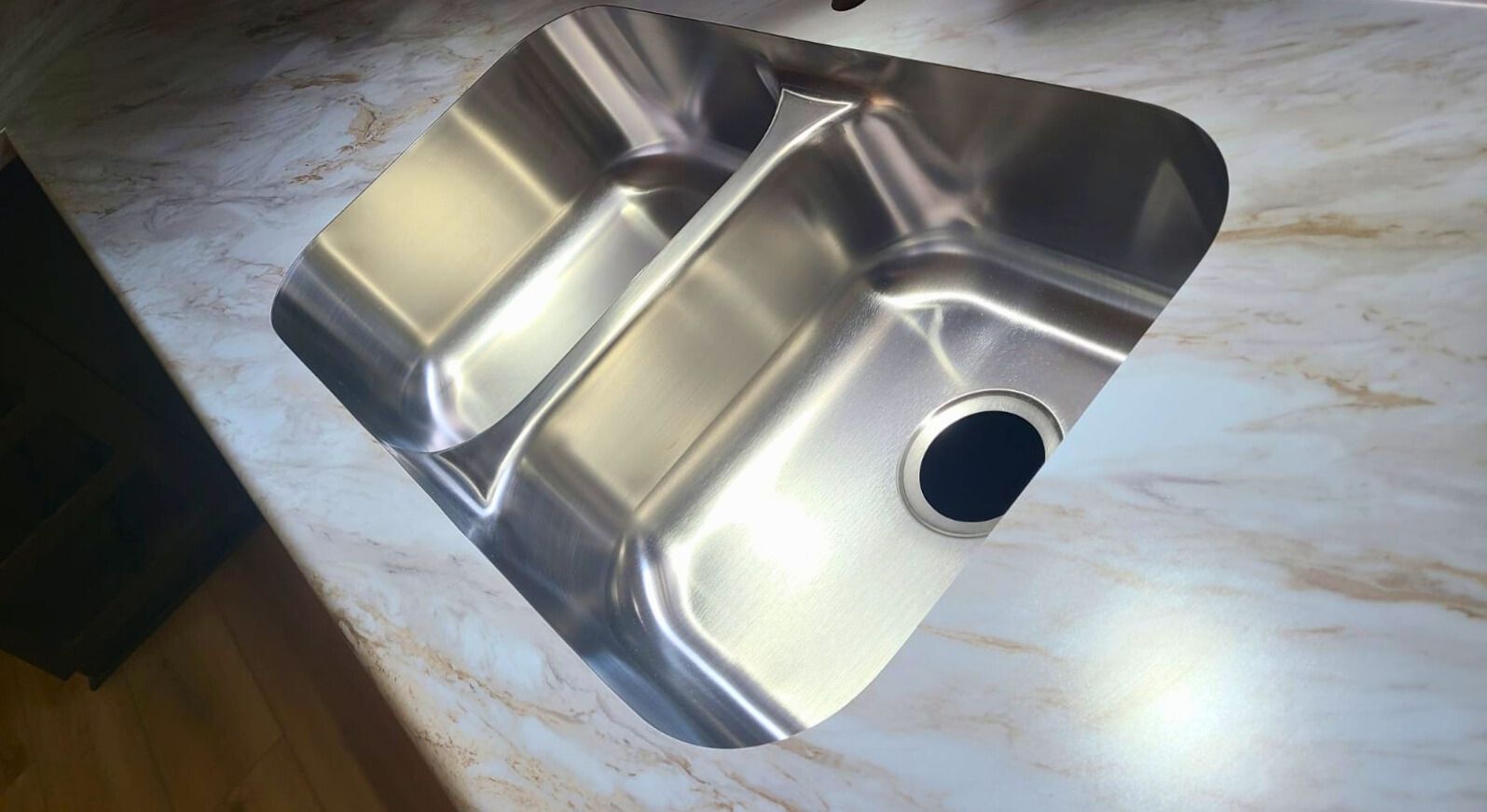 Stainless steel kitchen sink in a countertop. - after