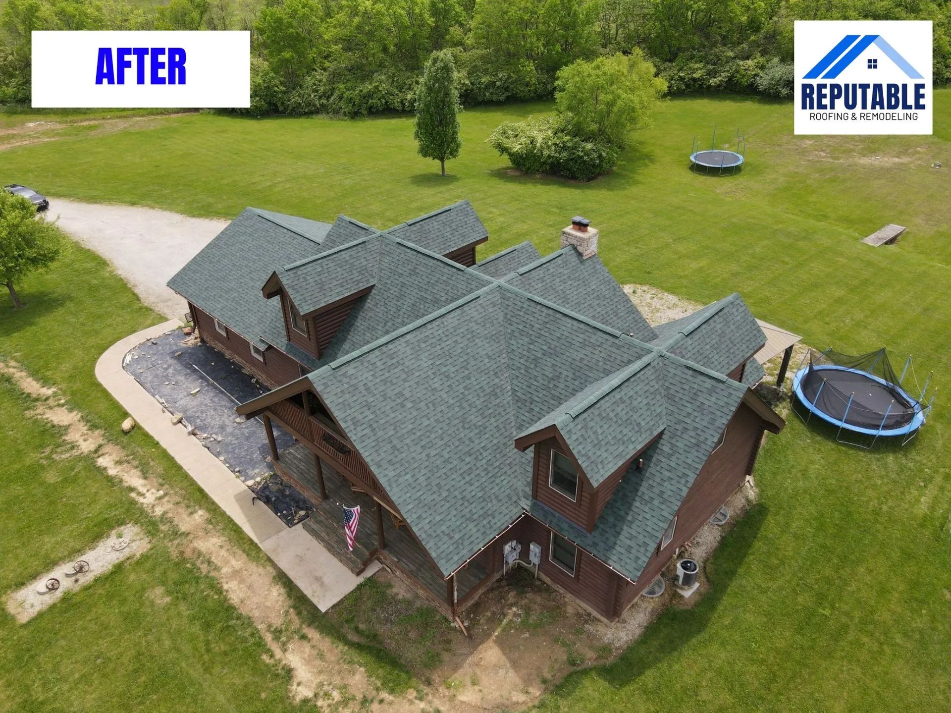 Aerial view of a house after roofing work, with a green lawn and trampoline nearby.