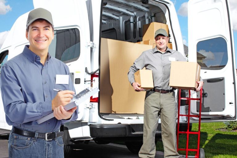 Two delivery workers with a white van, one writing on a clipboard, the other holding packages.
