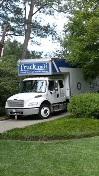 White moving truck parked in a driveway; 