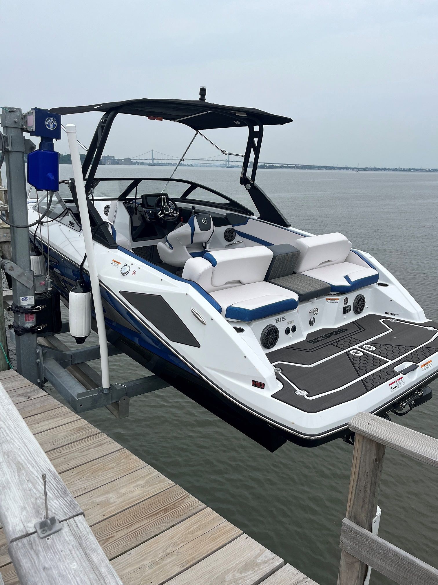 A white and blue boat is docked at a dock.