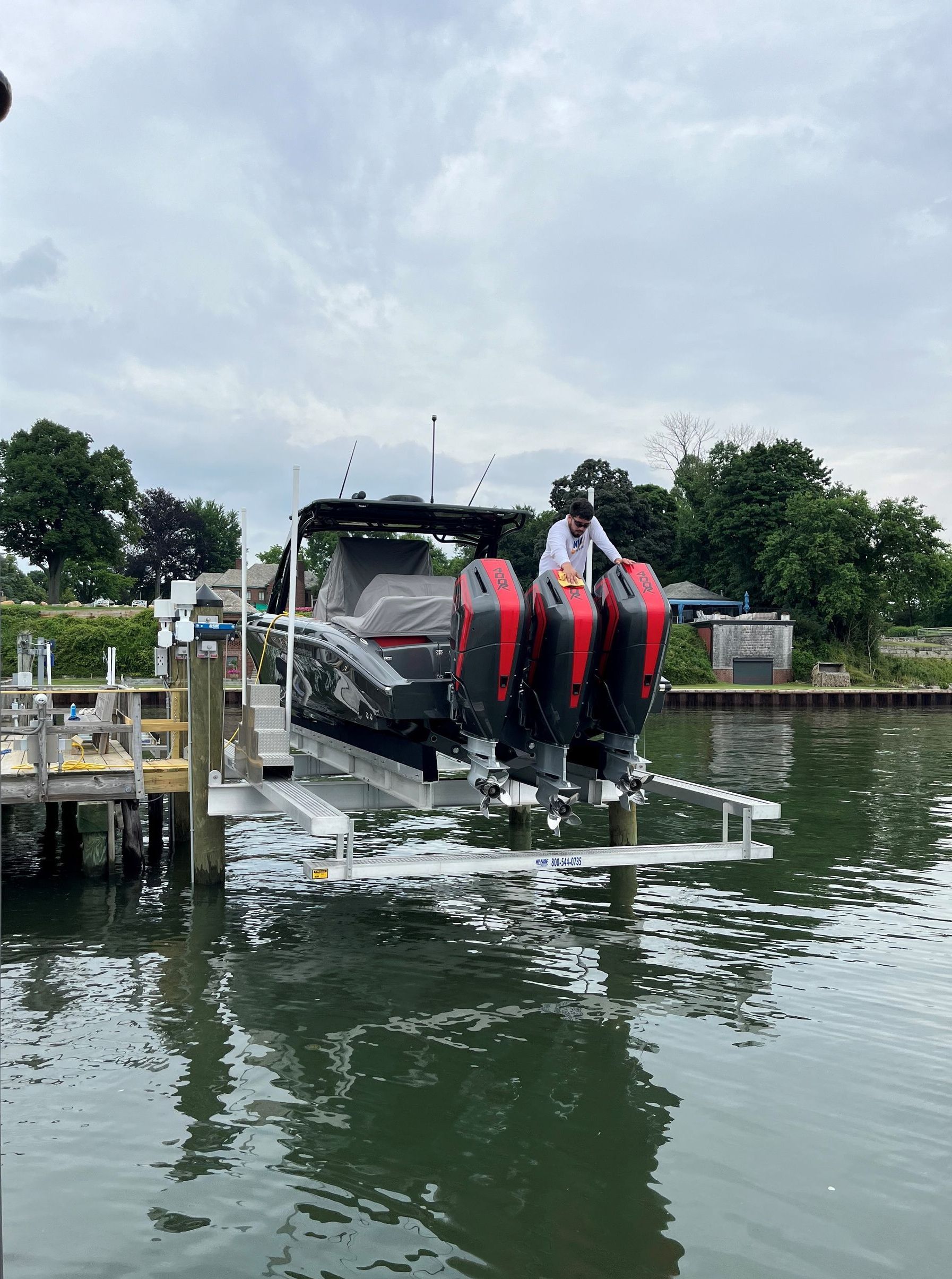 A boat is being lifted into the water by a dock