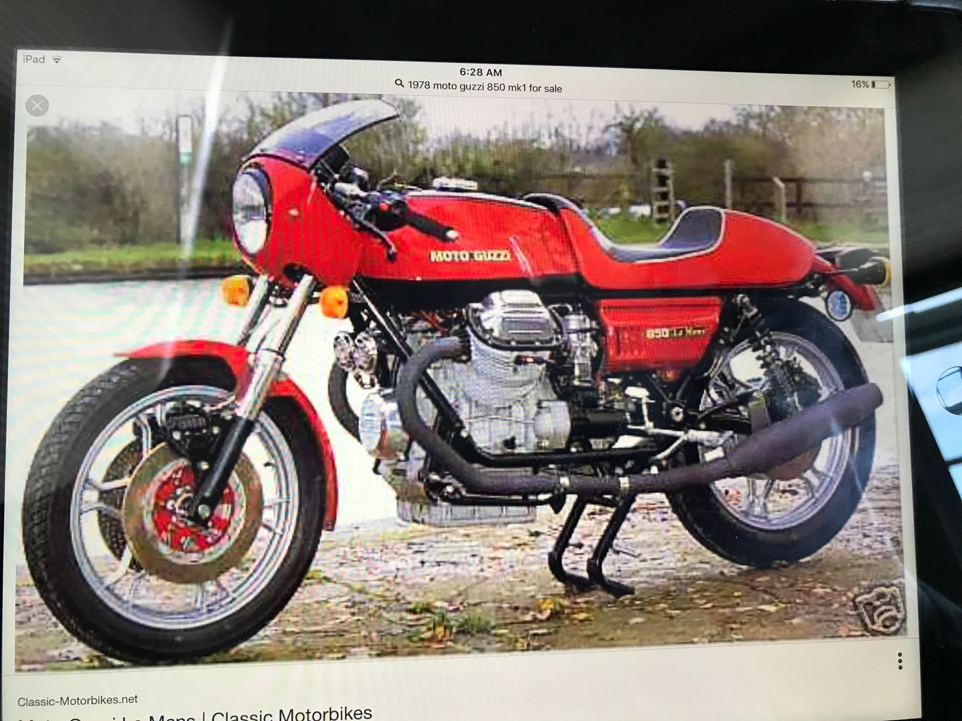 a red motorcycle with the word Guzzi on the side