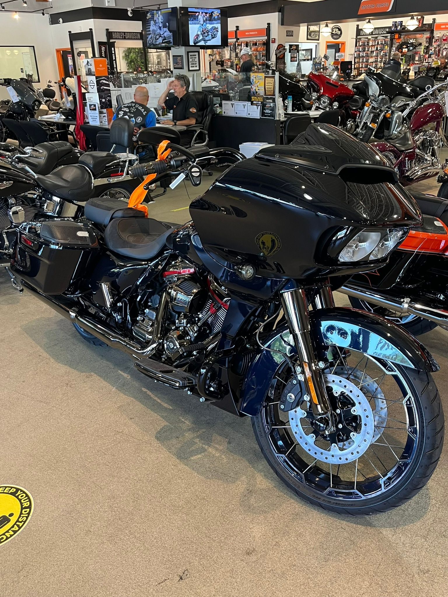 a black Harley Davidson motorcycle is parked in a showroom