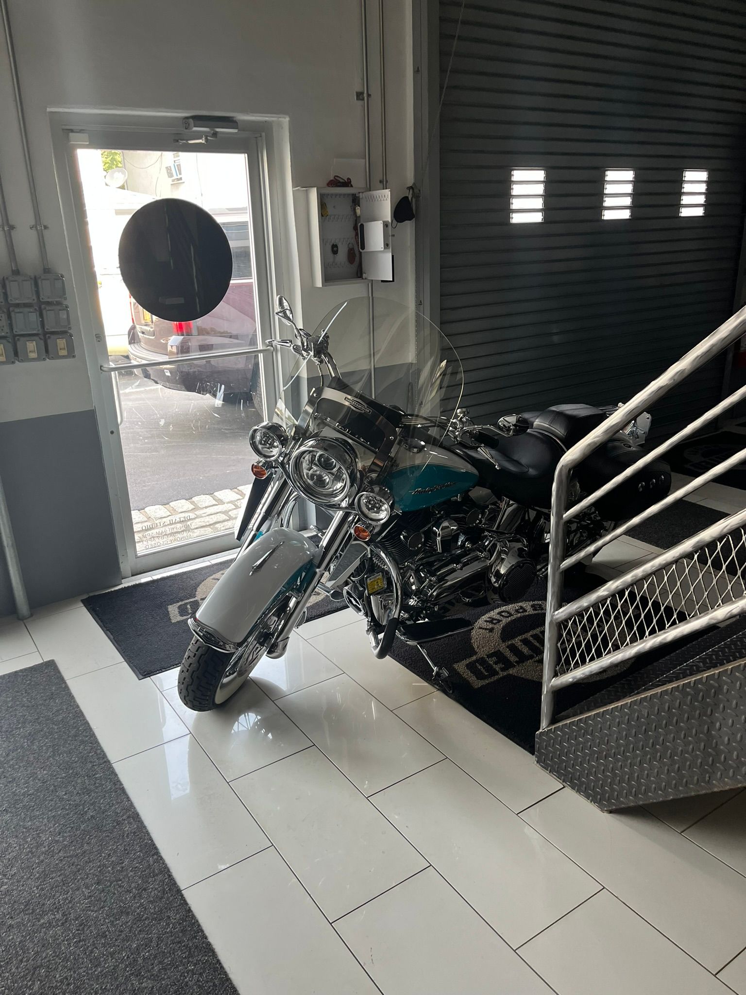 a motorcycle is parked in a garage next to stairs