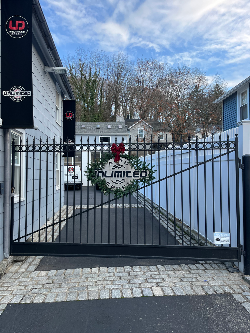 A sliding gate with a wreath on top of it