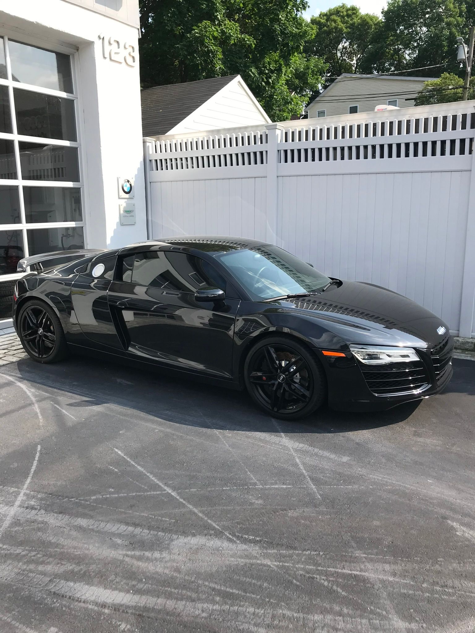 black car parked outside a showroom garage