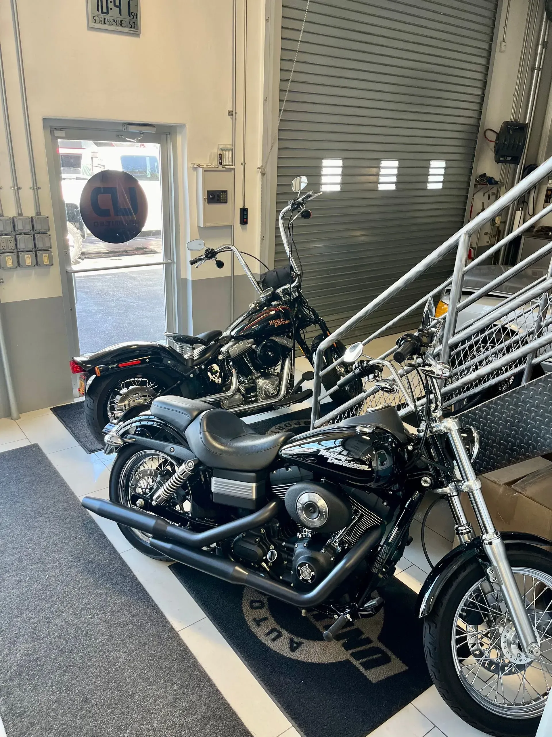 A row of motorcycles are parked in a garage.