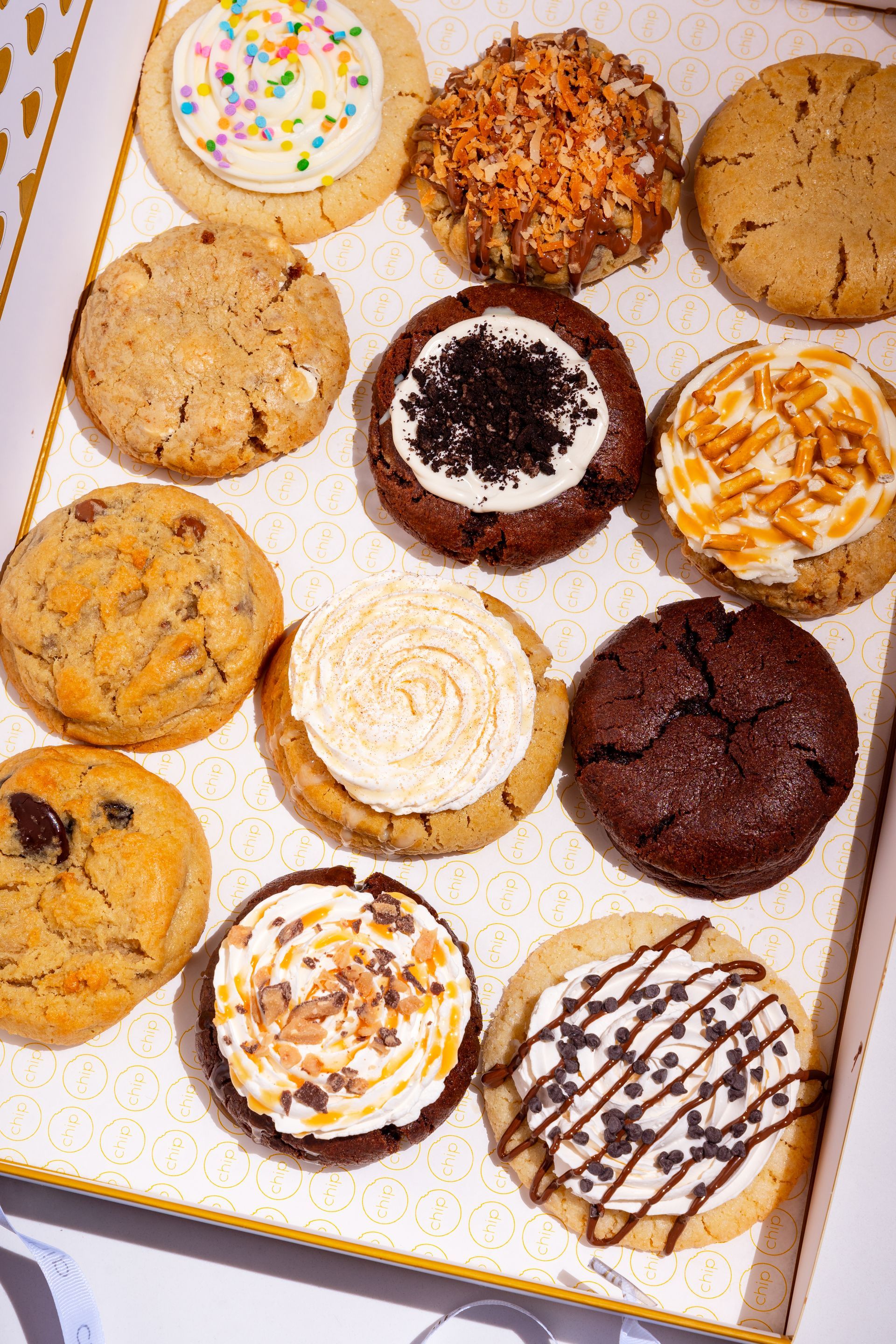 A stack of white boxes filled with chocolate chip cookies